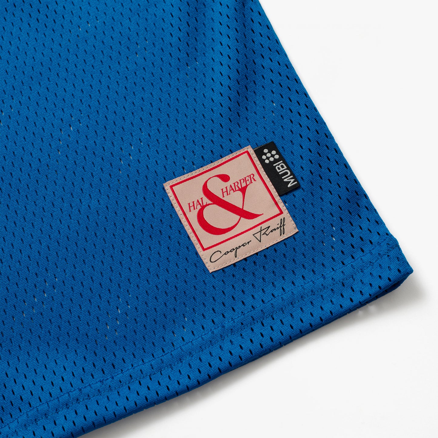 Blue mesh basketball jersey with a label featuring HAL & HARPER and MUBI label on a white background